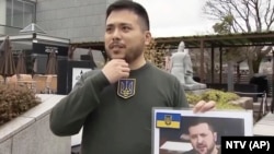 A Japanese student speaks in an interview and says why he chose to be Ukrainian President Volodymyr Zelenskyy's look-alike for his graduation ceremony in Kyoto, western Japan, March 24, 2023. 