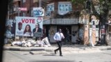 A man crosses a usually bustling avenue which had emptied as people anxiously wait for the results of the presidential elections, in Lagos, Nigeria, Feb. 28, 2023. 