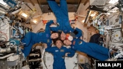 In this photo made available by NASA, clockwise from left, Anna Kikina of Roscosmos, Josh Cassada and Nicole Mann from NASA, and Koichi Wakata of Japan Aerospace Exploration Agency in the International Space Station's Kibo laboratory, March 1, 2023. 