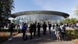 FILE - File - People stand outside of the Steve Jobs Theater before an event, Sept. 12, 2018. If Apple unveils a headset equipped with mixed reality technology Monday, it will be the company's biggest new product since the introduction of the Apple Watch.