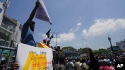 FILE - Sri Lankans shout slogans during a protest against the government increasing income tax to manage day to day expenses amid an unprecedented economic crisis in Colombo, Sri Lanka, on Feb. 22, 2023. (AP Photo/Eranga Jayawardena, File)