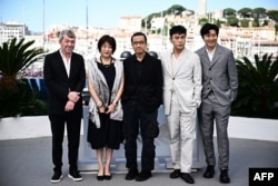 From left, producer Philippe Bober, producer Yingli Ma, director Lou Ye, actor Hao Qin and actor Huang Xuan are pictured during a photo call for "An Unfinished Film" at the Cannes Film Festival in France, May 17, 2024.