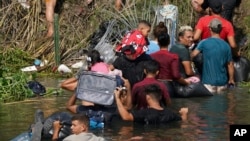 FILE - Venezuelan migrants are among those crossing the Rio Grande River, seen from Matamoros, Mexico, May 10, 2023. 