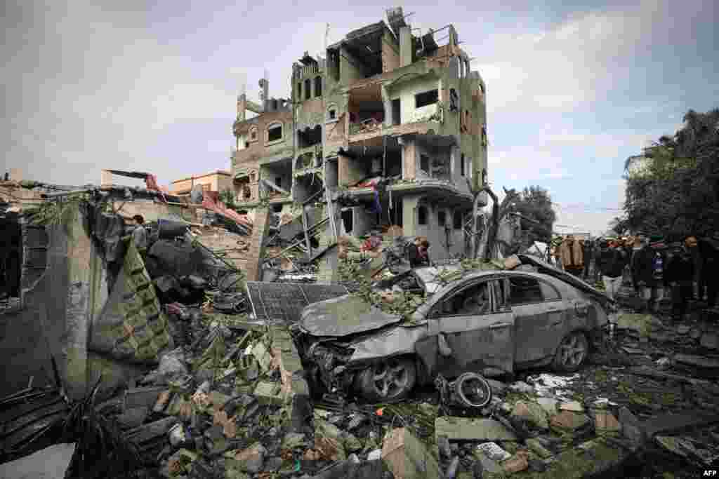 Palestinians inspect the damage at the Al-Maghazi refugee camp after an overnight Israeli strike.