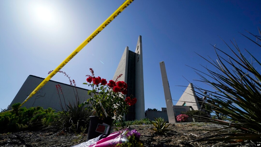 FILE - Flowers sit outside Geneva Presbyterian Church in Laguna Woods, California, on May 17, 2022, after a fatal shooting at the church on May 15, 2022. David Chou of Las Vegas, Nevada, has been charged with murder, attempted murder and hate crimes in connection with the attack.