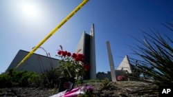 FILE - Flowers sit outside Geneva Presbyterian Church in Laguna Woods, California, on May 17, 2022, after a fatal shooting at the church on May 15, 2022. David Chou of Las Vegas, Nevada, has been charged with murder, attempted murder and hate crimes in connection with the attack.