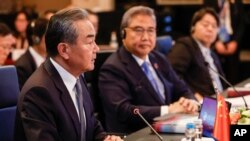 FILE - Chinese foreign policy chief Wang Yi, left, speaks as South Korean Foreign Minister Park Jin, center, and Japanese Foreign Minister Yoshimasa Hayashi listen during an ASEAN Plus Three foreign ministers meeting in Jakarta, Indonesia, July 13, 2023. 