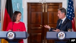 Secretary of State Antony Blinken, right, gestures to German Foreign Minister Annalena Baerbock as he speaks during a media briefing at the U.S. State Department in Washington, Sept. 15, 2023.