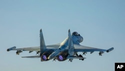 FILE - In this photo released by the Russian Defense Ministry's Press Service on June 25, 2021, a Su-35 fighter jet of the Russian air force takes off from Hemeimeem air base in Syria.