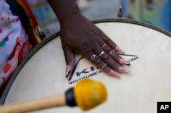 A member of the Turma da Paz de Madureira, or TPM, samba school plays a drum during a rehearsal Feb. 4, 2023. (AP Photo/Silvia Izquierdo)