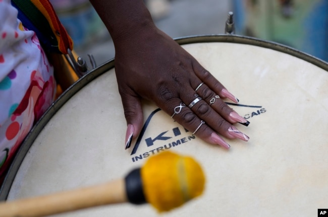 A member of the Turma da Paz de Madureira, or TPM, samba school plays a drum during a rehearsal Feb. 4, 2023. (AP Photo/Silvia Izquierdo)