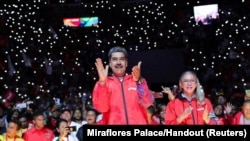 Venezuela's President Nicolas Maduro celebrates with supporters after saying he's running for another term in the July 28, 2024 election, at the Poliedro de Caracas, Venezuela, March 16, 2024.
