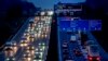 FILE - Cars and trucks drive on a highway in Frankfurt, Germany, Jan. 27, 2023. 