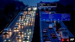 FILE - Cars and trucks drive on a highway in Frankfurt, Germany, Jan. 27, 2023. 