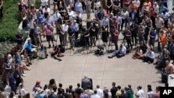 Wisconsin Gov. Tony Evers, at lectern, speaks at the fifth annual Pride Month celebration, just ahead of the raising of the Pride Flag at the Wisconsin State Capitol, June 1, 2023, in Madison, Wis.