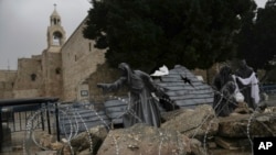 A Nativity scene decorated to honor the victims in Gaza is displayed in Manger Square, near the Nativity Church, which is traditionally believed to be the birthplace of Jesus, on Christmas Eve, in the West Bank city of Bethlehem, Dec. 24, 2023.