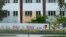 FILE - A security agent walks alongside a barrier surrounding Marjory Stoneman Douglas High School in Parkland, Florida, July 5, 2023. 