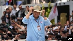 Presidential candidate Prabowo Subianto adjusts his hat as he leaves after registering his candidacy with his running mate Gibran Rakabuming Raka to run in the 2024 election, at the General Election Commission building in Jakarta, Oct. 25, 2023. 