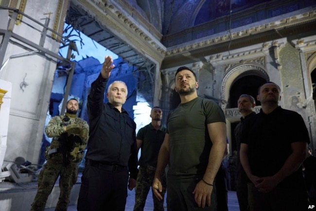 FILE - In this photo provided by the Ukrainian Presidential Press Office, Ukrainian President Volodymyr Zelenskyy, center right, inspects damage of the Odesa Transfiguration Cathedral in Odesa on July 27, 2023.