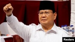 FILE - Indonesian Defense Minister Prabowo Subianto gestures while attending a meeting of his Gerindra Party, in Bogor, Indonesia, Aug. 12, 2022.