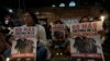 Demonstrators take part in a vigil holding posters reading, 'No more culture of violence' during a protest against bullfighting in Bogota, Colombia, May 24, 2024.