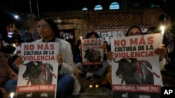 Demonstrators take part in a vigil holding posters reading, 'No more culture of violence' during a protest against bullfighting in Bogota, Colombia, May 24, 2024.