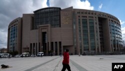 FILE - A person walks past the Caglayan Justice Palace courthouse in Istanbul on March 21, 2022. 