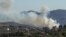 FILE - Smoke billows from a site targeted by the Israeli military in the southern Lebanese border village of Kafr Kila on July 29, 2024.