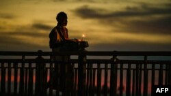 A street hawker waits for customers at the Galle Face Beach in Colombo on March 20, 2023.