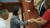 Taiwan's President Tsai Ing-wen, center, shakes hands with a senator at the end of her visit to the National Assembly in Belmopan, Belize, April 3, 2023. Tsai is in Belize for an official three-day visit.