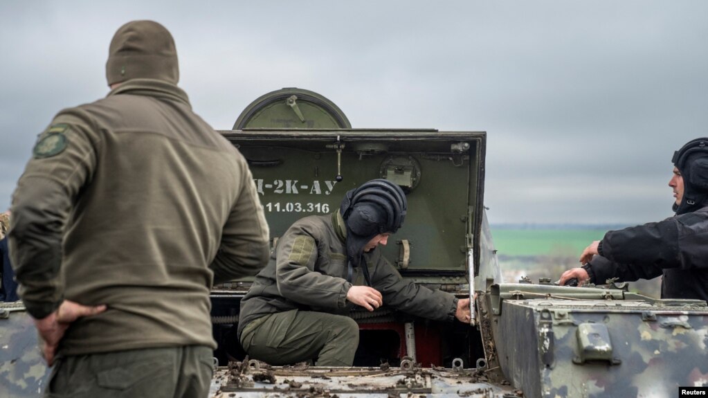 FILE - Servicemen stand near a military vehicle at a defense position, where Ukraine's National Guard prepares to defend Odesa, Apr. 10, 2023. (Ritzau Scanpix/Bo Amstrup via Reuters) 
