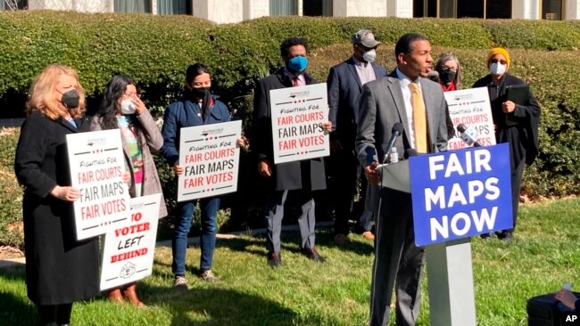 FILE - Reggie Weaver, at podium, speaks outside the Legislative Building in Raleigh, N.C, on Feb. 15, 2022, about a recent partisan gerrymandering ruling by the North Carolina Supreme Court.