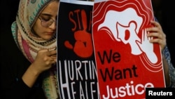 Medical students hold posters as they attend a protest against what they say was rape and murder of a trainee doctor, inside the premises of R G Kar Medical College and Hospital in Kolkata, India, Aug. 13, 2024.