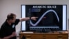 FILE - A professor of the British Antarctic Survey explains a graph on the state of Antarctic sea ice at different years, at the British Antarctic Survey's headquarters in Cambridge, June 19, 2023.