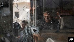 A bullet hole is seen in a shop window following an Israeli military raid in the Jenin refugee camp, West Bank.&nbsp;Palestinian health officials say the death toll over a day of fighting between Israel and the Palestinians in the occupied West Bank and the Gaza Strip has risen to six, four from Jenin.&nbsp;