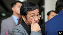 FILE - Filipino journalist Maria Ressa, 2021 Nobel Peace Prize winner and Rappler CEO, gestures as she talks to reporters after being acquitted in a tax evasion case in Pasig city, Philippines, on Sept. 12, 2023.