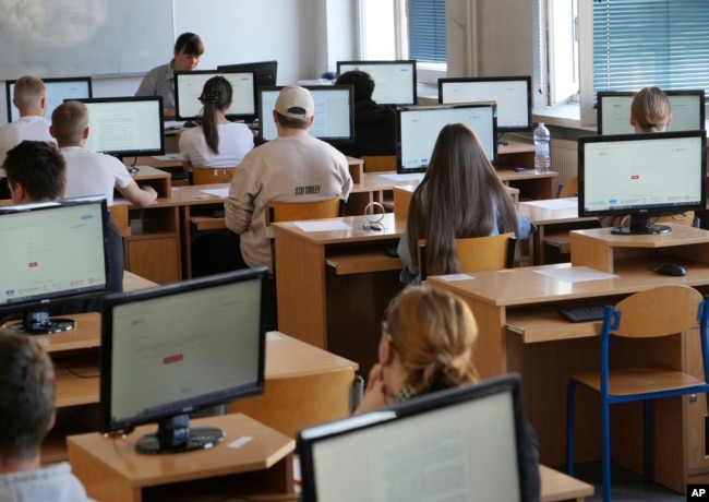 Students take the Ukrainian final state examination, a test after high school for those who hope to attend university, in Warsaw, Poland, Wednesday June 7, 2023. (AP Photo/Czarek Sokolowski)