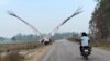 Arif Gurjar rides his motorcycle near his home in Mandkha, Uttar Pradesh, India, as a Sarus crane named "Sarus" follows. Gurjar found and rescued the injured bird, which continued to stay close to him after it recovered from its injuries until it was taken away to a zoo. 