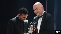 FILE: Argentina and Paris Saint-Germain forward Lionel Messi (L) receives from FIFA President Gianni Infantino the Best FIFA Mens Player award during the Best FIFA Football Awards 2022 ceremony in Paris on February 27, 2023. 