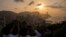Visitors look at sunset from a hill in Hong Kong, March 22, 2024. 