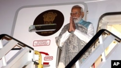 FILE - India's Prime Minister Narendra Modi gestures as he arrives at the Sydney international airport, May 22, 2023, on visit to Australia. 