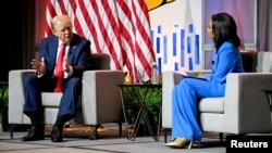 Republican presidential nominee and former U.S. President Donald Trump, left, speaks as he faces Rachel Harris of ABC News during a panel at the National Association of Black Journalists convention in Chicago, Illinois, July 31, 2024. 