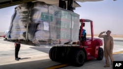 A team from King Salman Humanitarian Aid and Relief Centre load humanitarian aid inside a Saudi military C130 plane before it takes off from King Khalid airport to Port Sudan, in Riyadh, Saudi Arabia, May 10, 2023.