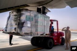 A team from King Salman Humanitarian Aid and Relief Centre load humanitarian aid inside a Saudi military C130 plane before it takes off from King Khalid airport to Port Sudan, in Riyadh, Saudi Arabia, May 10, 2023.