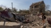 A woman looks at a crater following an air attack in the Odesa region of Ukraine, on Aug. 26, 2024.