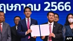 Move Forward Party leader and prime ministerial candidate Pita Limjaroenrat and Pheu Thai Party leader Cholanan Srikaew hold a memorandum of understanding signed by political parties in agreement to form a new government, in Bangkok, May 22, 2023
