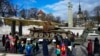 Russians Place Flowers at Burned-Out Tanks in Baltic Cities 