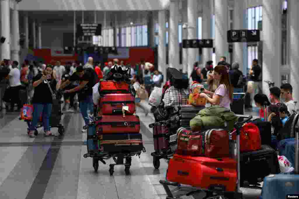 People wait with their luggage at Beirut-Rafic Hariri International Airport, in Beirut, Lebanon.