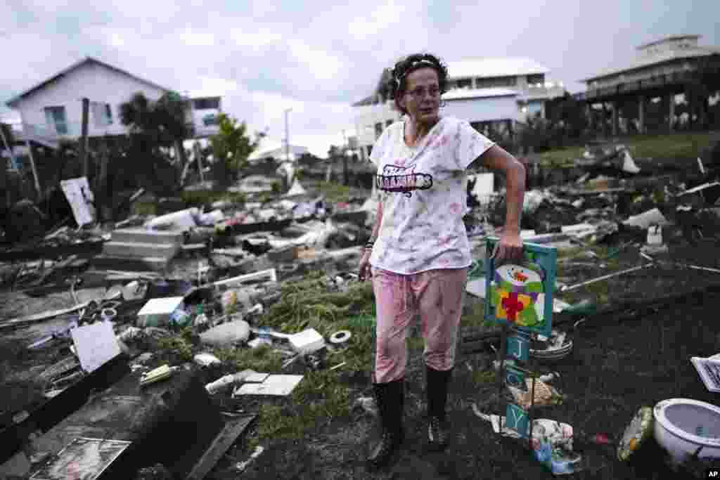 Jewell Baggett stands beside a Christmas decoration she recovered from the wreckage of her mother&rsquo;s home in Horseshoe Beach, Florida, after the passage of Hurricane Idalia, Aug. 30, 2023.