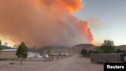 FILE - Fire and smoke rise from the Silver King Fire in Marysvale, Piute County, Utah, U.S., July 6, 2024 in this screen grab obtained from a social media video. (Trevor Urry/via Reuters) 